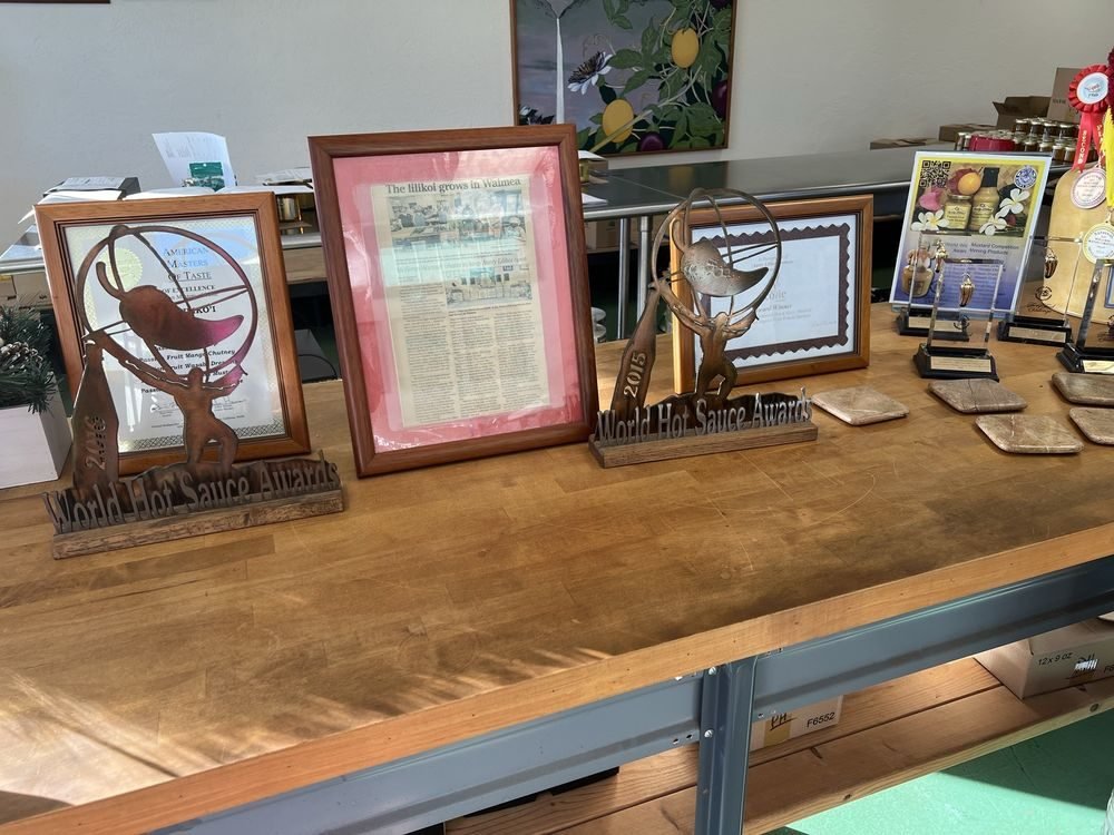 Trophies and framed award certificates on display inside the Aunty Lilikoʻi factory store